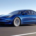 2022 Tesla Model 3 driving blue REL