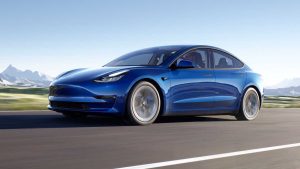 2022 Tesla Model 3 driving blue REL