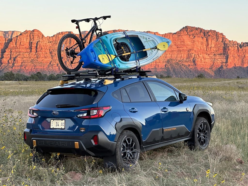 2024 Subaru Crosstrek Wilderness - rear 3-4 kayak bike and mountains