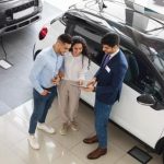 Customers at car dealer top shot