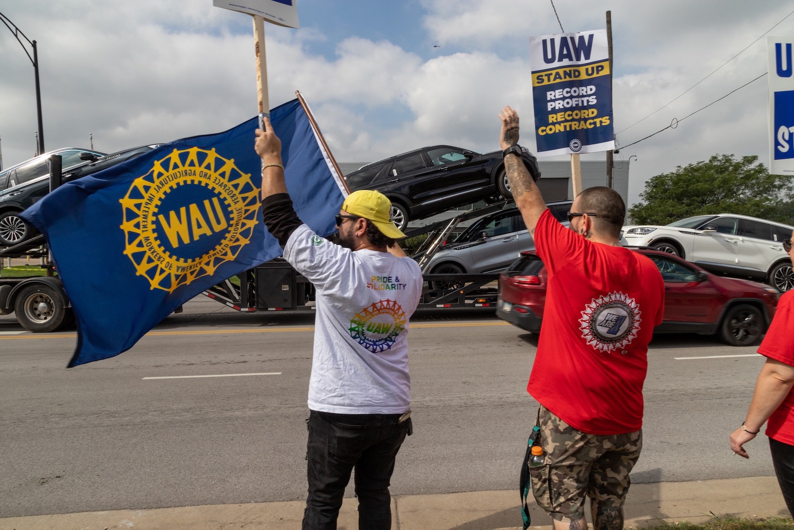 UAW picketers wave at car carrier 10-1-23