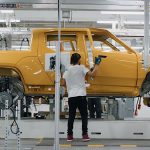 Rivian worker on production line