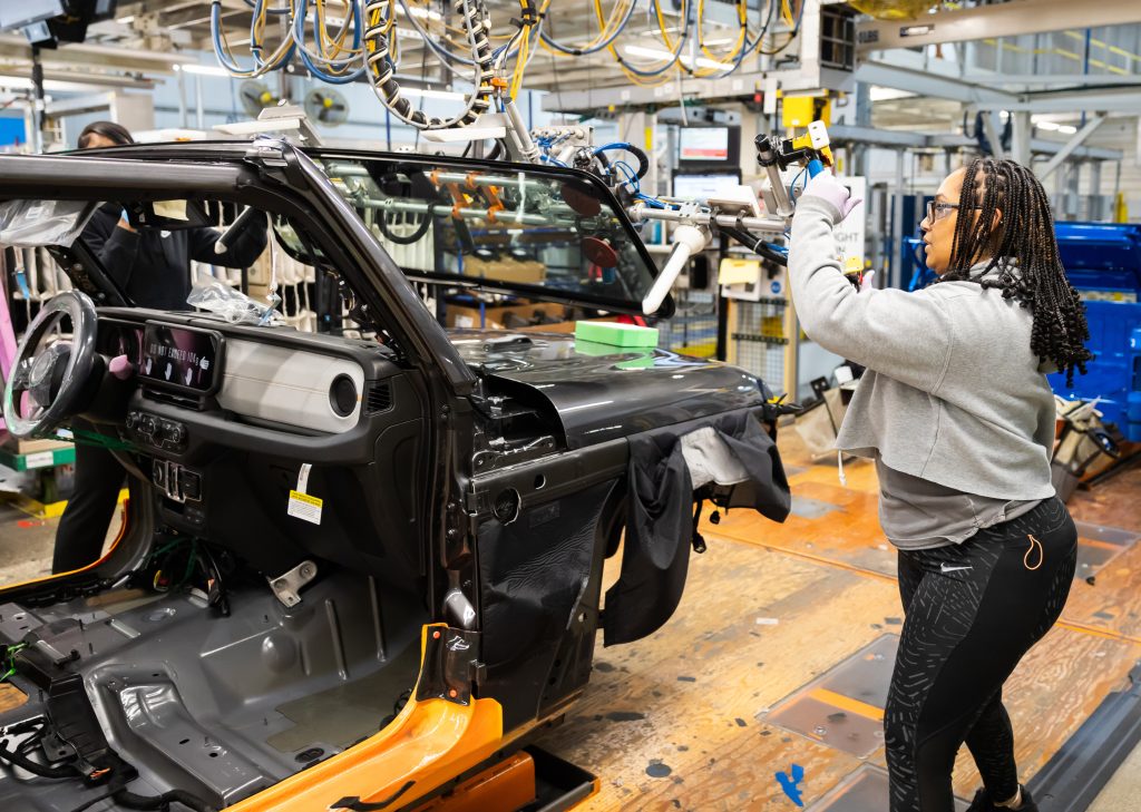 Production operators at the Toledo Assembly Complex move the win