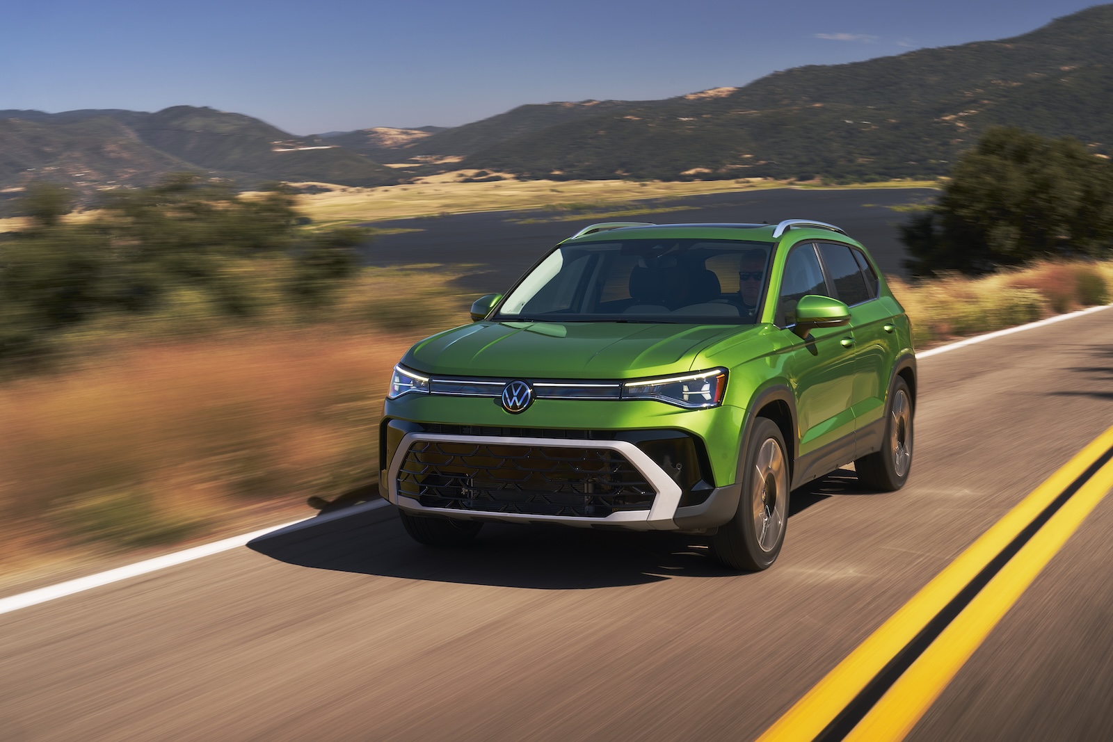 2025 VW Taos driving green REL