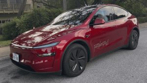 Tesla Model Y Robotaxi red parked