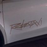 Tesla Model Y robotaxi white logo