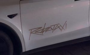 Tesla Model Y robotaxi white logo