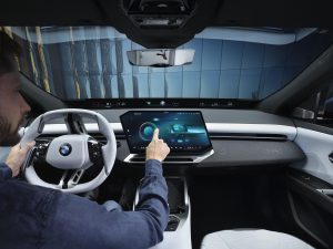 BMW iX3 - driver operating touchscreen
