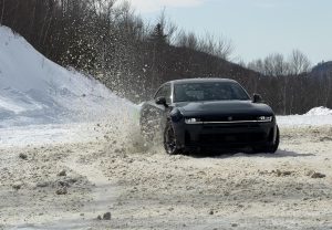 2026 Dodge Charger RT - Sedan kicking up snow on track